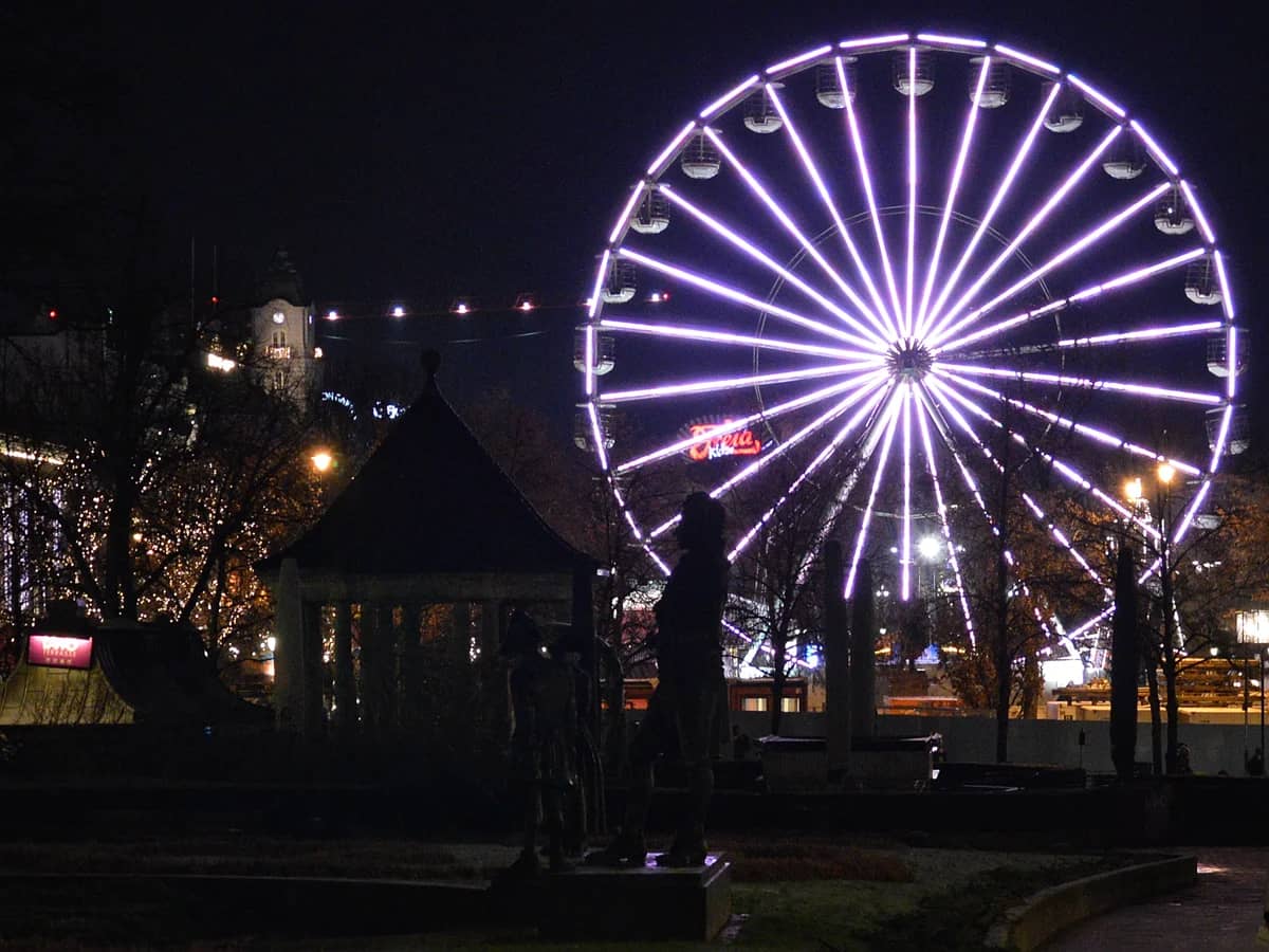 Oslo ferris wheel illuminated in purple neon during winter evening