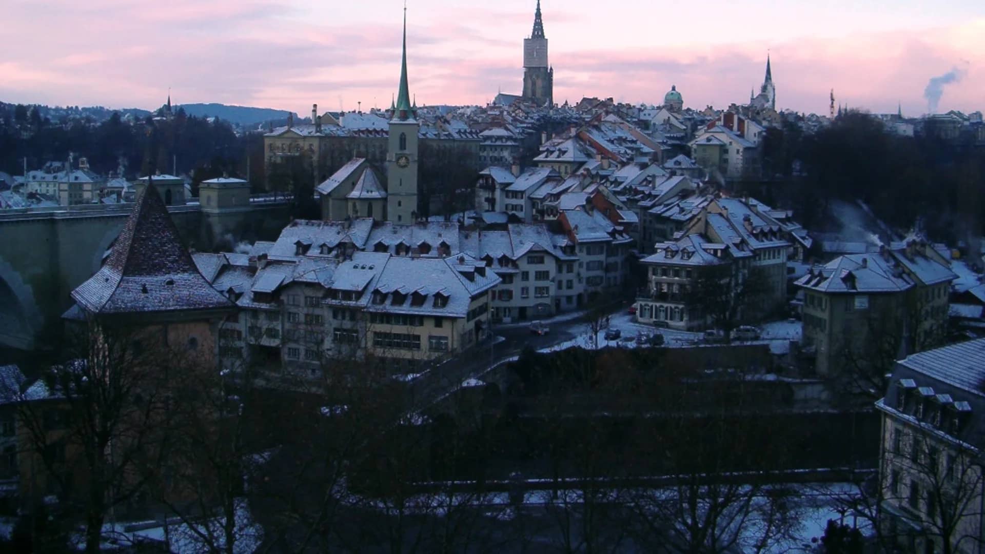 Bern skyline glowing under twilight skies during winter season